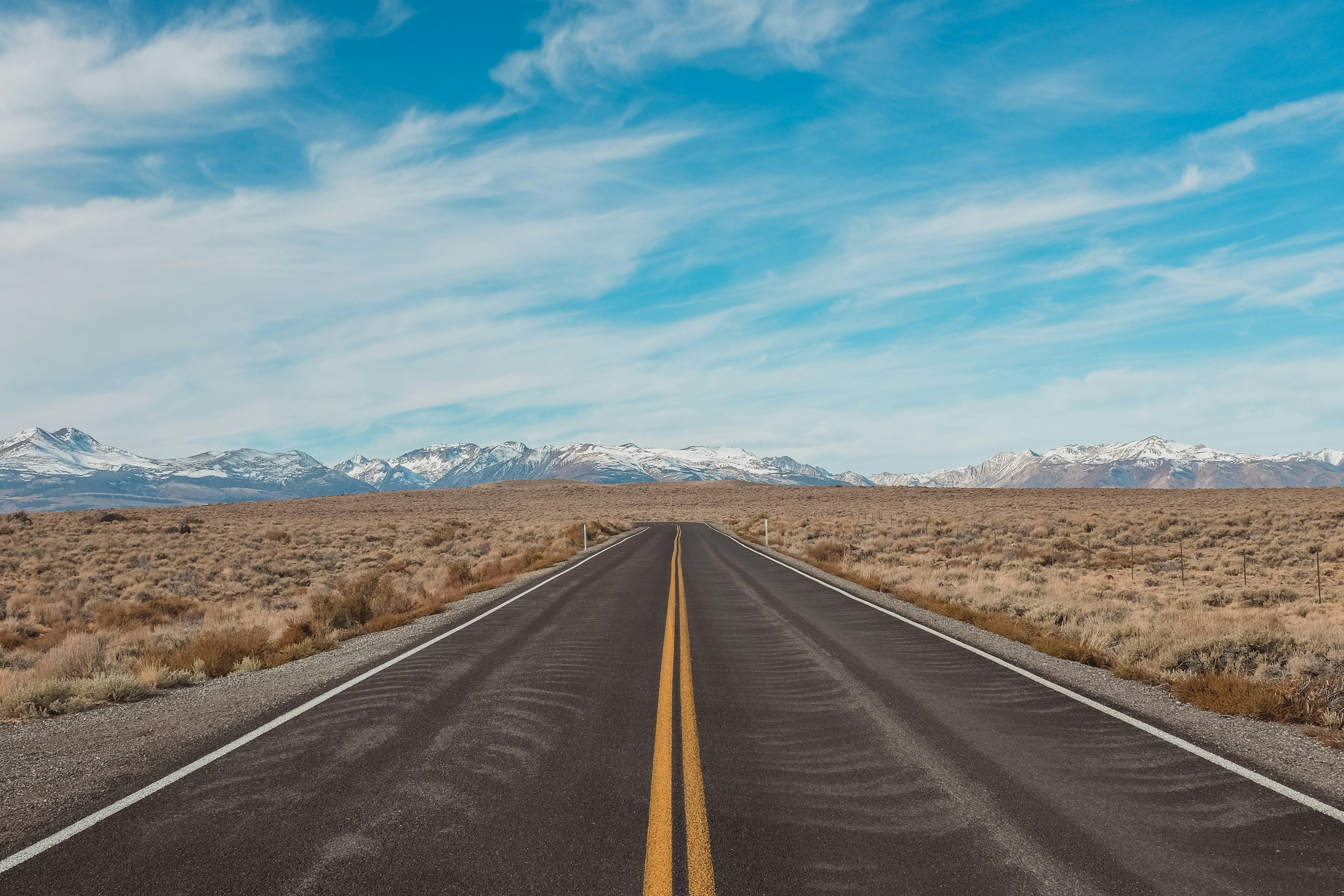 gray concrete road under blue sky during daytime